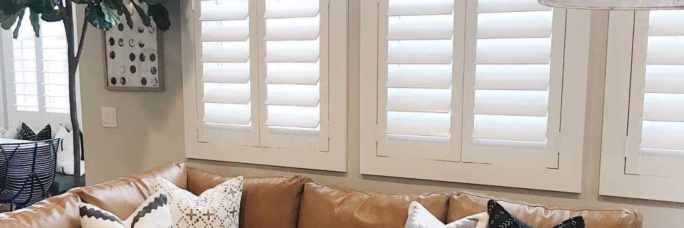 White Polywood shutters on windows in a living room